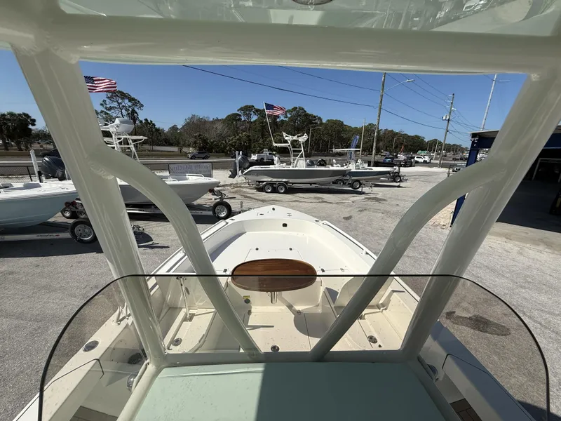 Slide: The Image of 2024 Pathfinder 2600 TRS boat at a dealership, surrounded by other boats and trailers. - 38