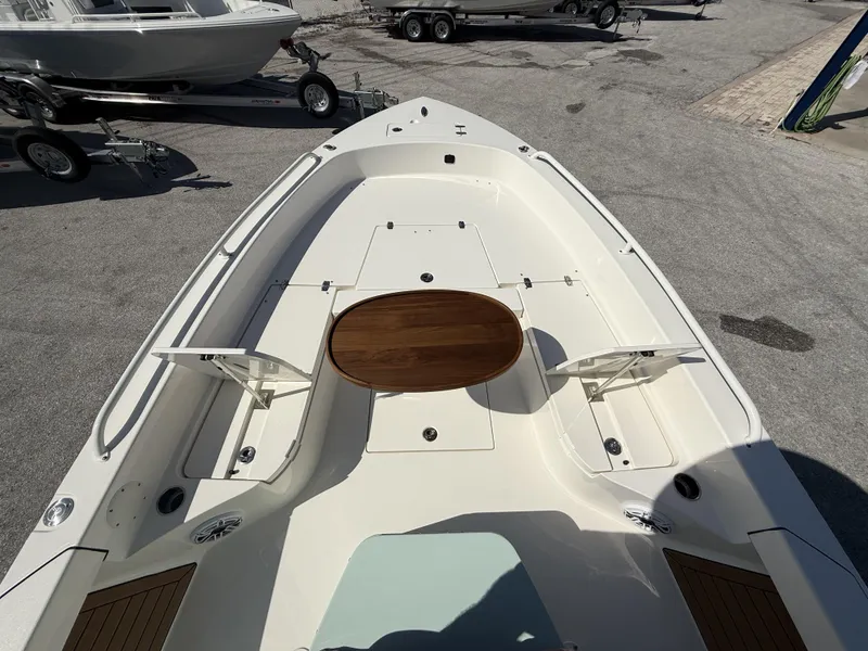 Slide: The Image of 2024 Pathfinder 2600 TRS boat deck with wooden table, parked on a trailer. - 39