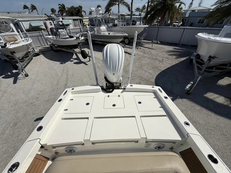 Slide: The Image of 2024 Pathfinder 2600 TRS boat deck with motor, surrounded by other boats. - 41