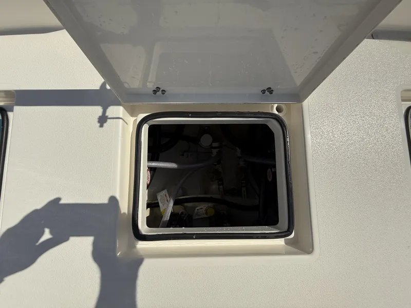 Slide: The Image of Open hatch on 2024 Pathfinder 2600 TRS boat deck, revealing internal compartment. - 44