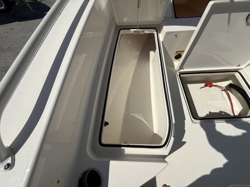 Slide: The Image of 2024 Pathfinder 2600 TRS boat storage compartments, open and empty, showcasing interior space. - 49