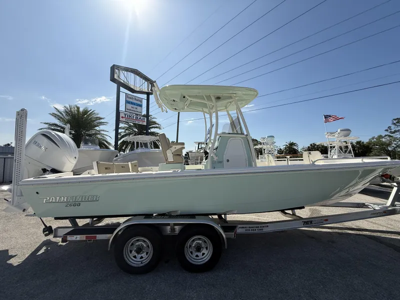 Slide: The Image of 2024 Pathfinder 2600 TRS boat on trailer, displayed outdoors under clear sky. - 5