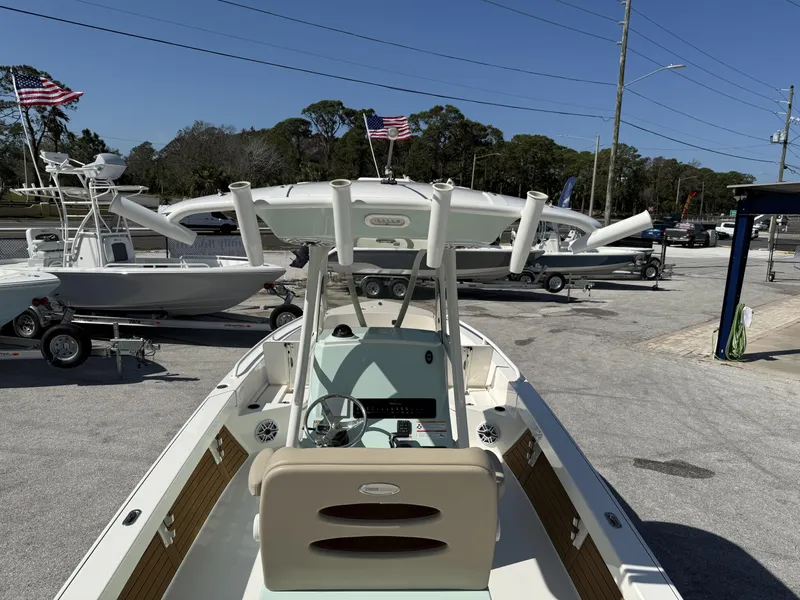 Slide: The Image of 2024 Pathfinder 2600 TRS boat displayed outdoors with American flags in the background. - 9