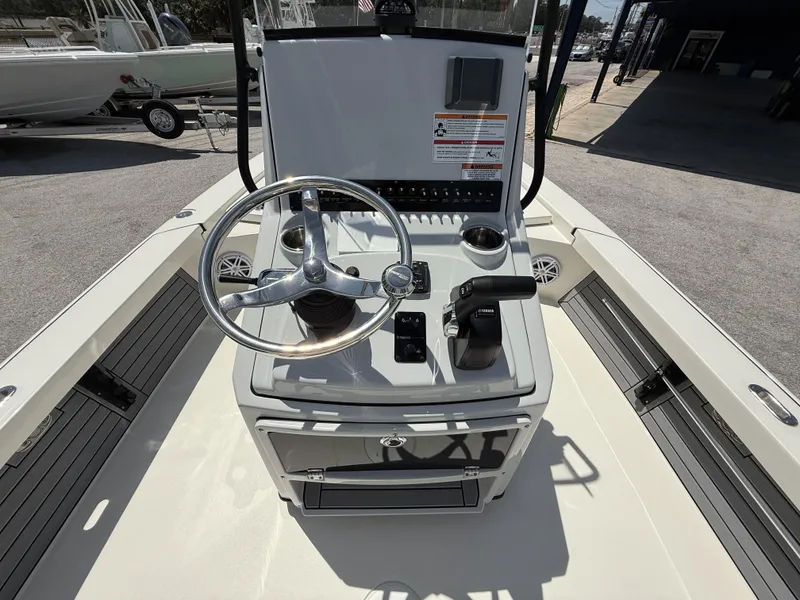 Slide: The Image of 2024 Pathfinder 2300 HPS boat console with steering wheel and controls. - 10