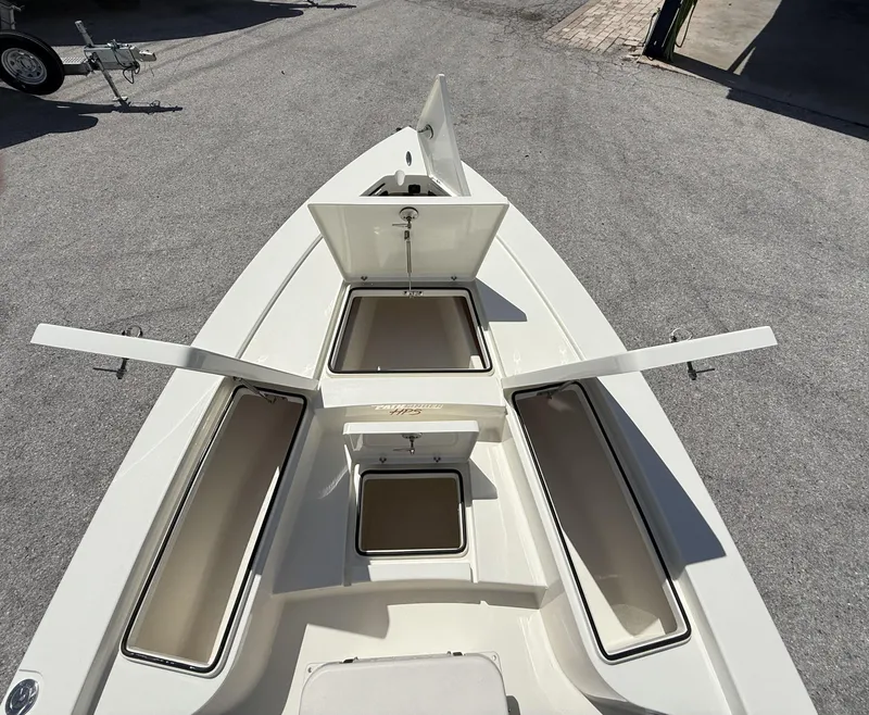 Slide: The Image of 2024 Pathfinder 2300 HPS boat with open storage compartments on deck. - 29