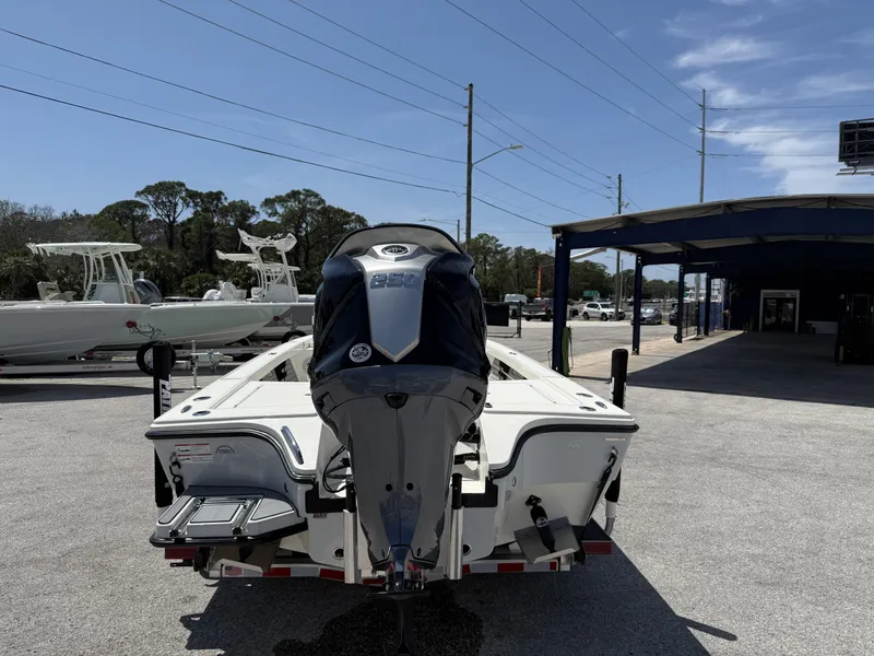 Slide: The Image of 2024 Pathfinder 2300 HPS boat with powerful outboard motor, parked outdoors under clear sky. - 3