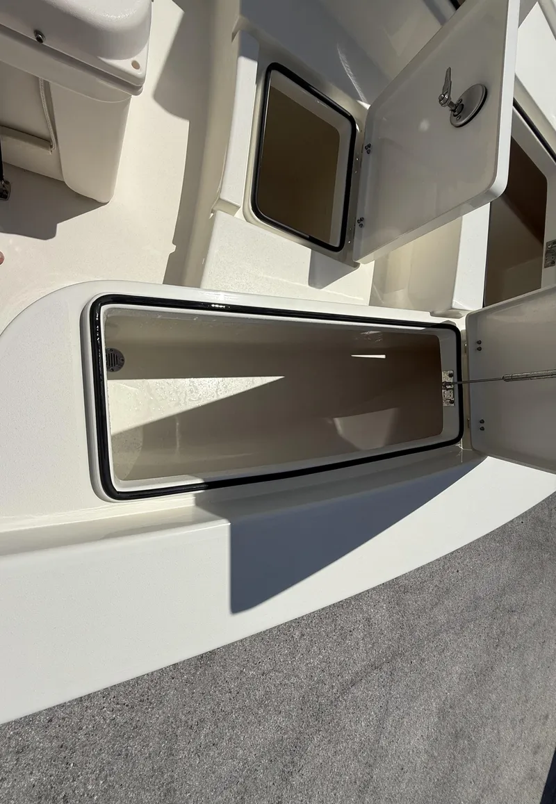 Slide: The Image of 2024 Pathfinder 2300 HPS boat storage compartments with open hatches. - 32