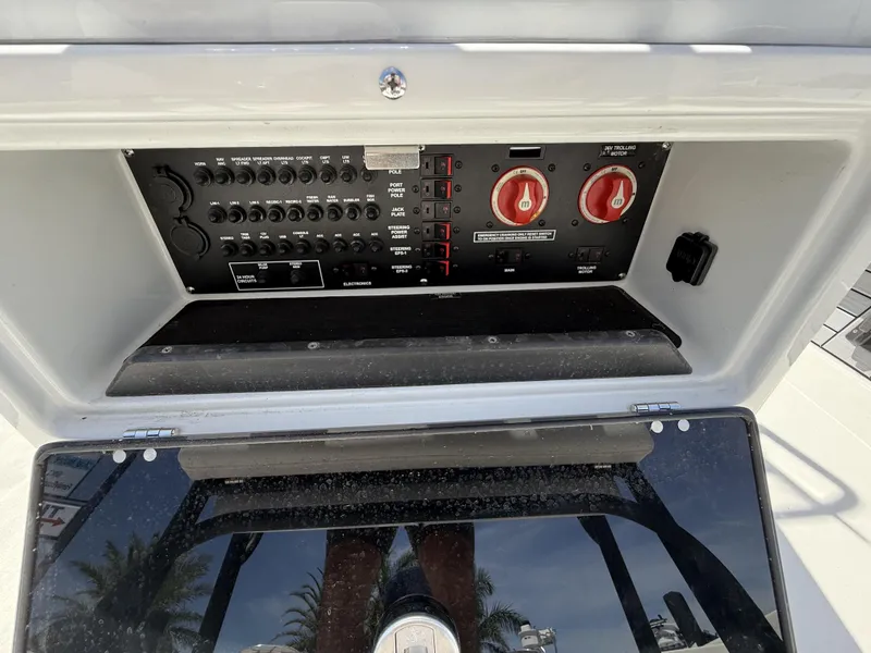 Slide: The Image of 2024 Pathfinder 2300 HPS boat control panel with switches and dials. - 35