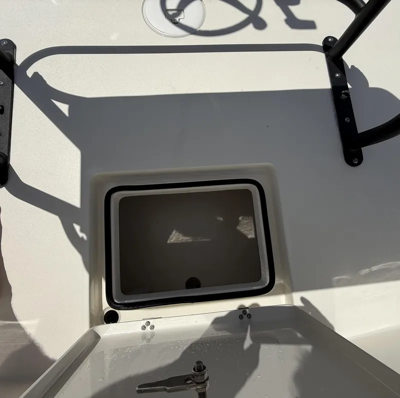 Slide: The Image of 2024 Pathfinder 2300 HPS boat interior with open storage compartment and steering wheel. - 36