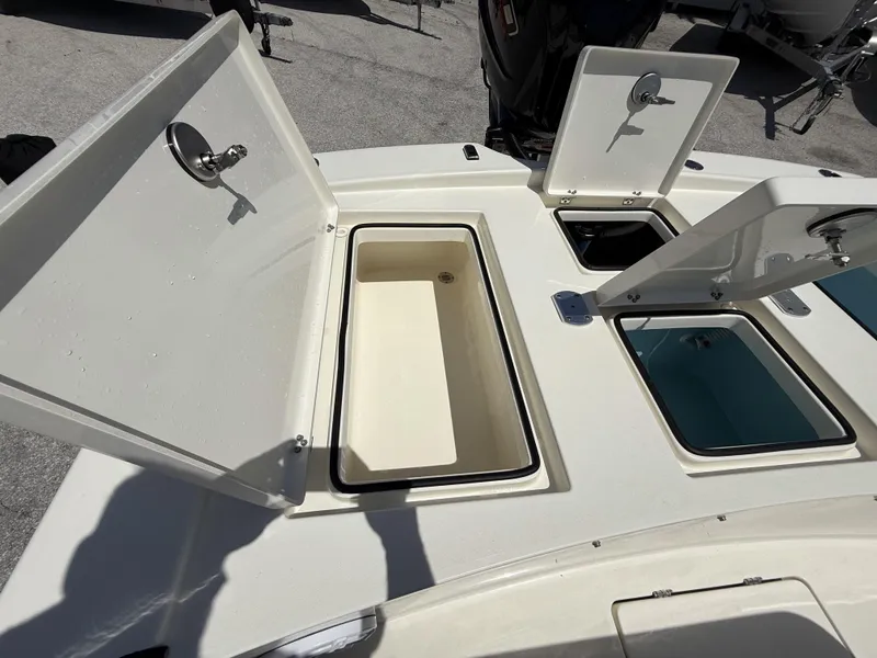Slide: The Image of 2024 Pathfinder 2300 HPS boat storage compartments open, showcasing interior design. - 38