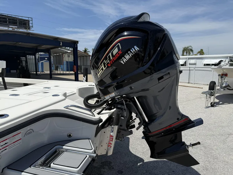 Slide: The Image of 2024 Pathfinder 2300 HPS boat with Yamaha outboard motor in a marina setting. - 4