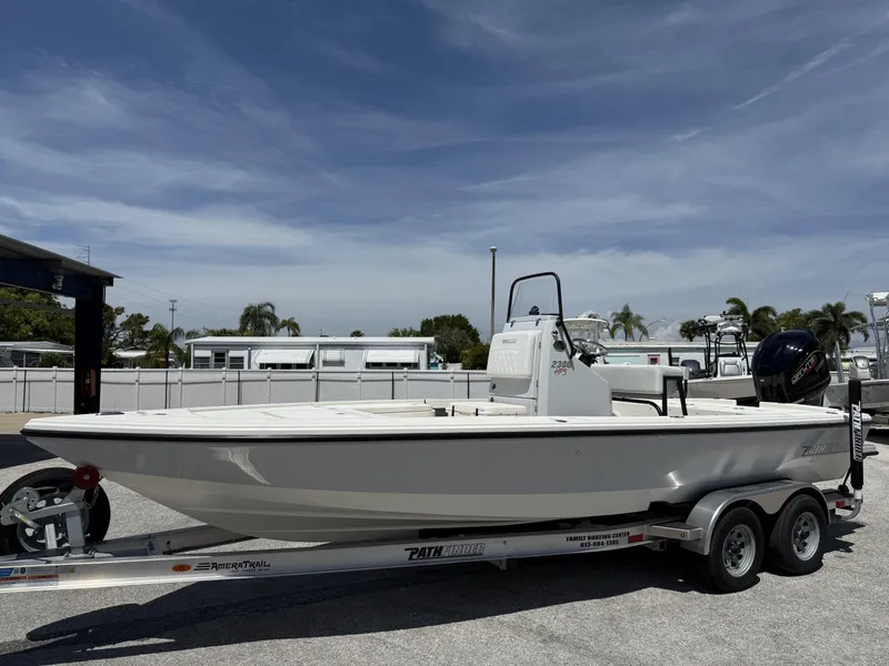 Slide: The Image of 2024 Pathfinder 2300 HPS boat on trailer under clear sky. - 6