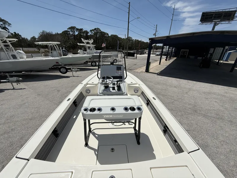 Slide: The Image of 2024 Pathfinder 2300 HPS boat displayed outdoors, showcasing console and seating area. - 9