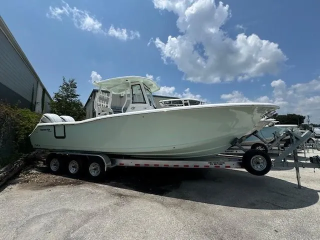 Slide: The Image of 2024 Tidewater 292 CC Adventure boat on trailer under a blue sky. - 1