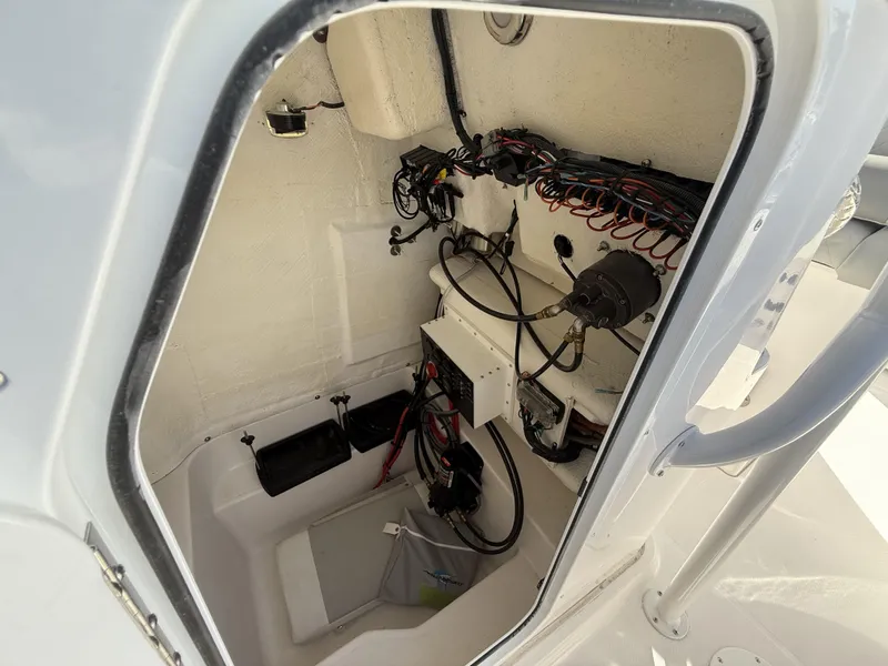 Slide: The Image of Interior wiring of 2024 Aquasport 2300 CC boat, showcasing electrical components and connections. - 14