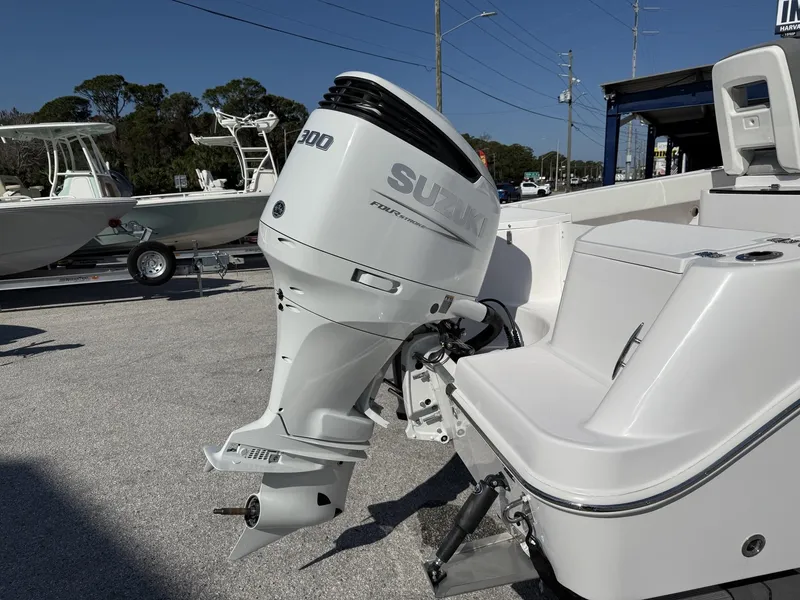 Slide: The Image of 2024 Aquasport 2300 CC boat with Suzuki 300 outboard motor, parked on a trailer. - 21