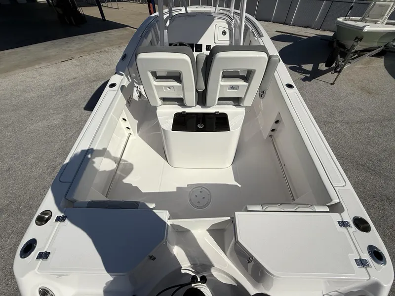 Slide: The Image of 2024 Aquasport 2300 CC boat interior with seating and storage compartments. - 25