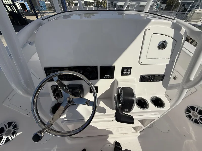 Slide: The Image of 2024 Aquasport 2300 CC boat console with steering wheel and controls. - 27