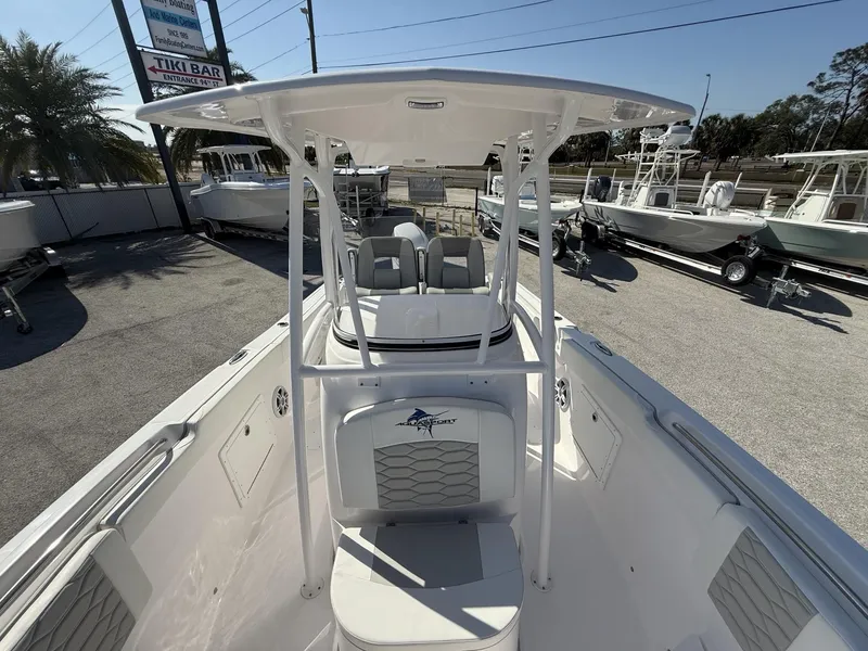 Slide: The Image of 2024 Aquasport 2300 CC boat with T-top, parked outdoors in a dealership lot. - 30