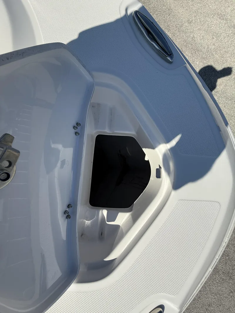 Slide: The Image of Open storage compartment on 2024 Aquasport 2300 CC boat deck. - 38