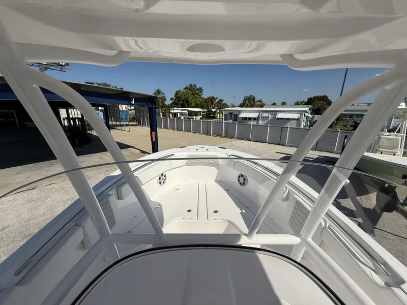 Slide: The Image of 2024 Aquasport 2300 CC boat interior, showcasing spacious deck and seating area. - 8