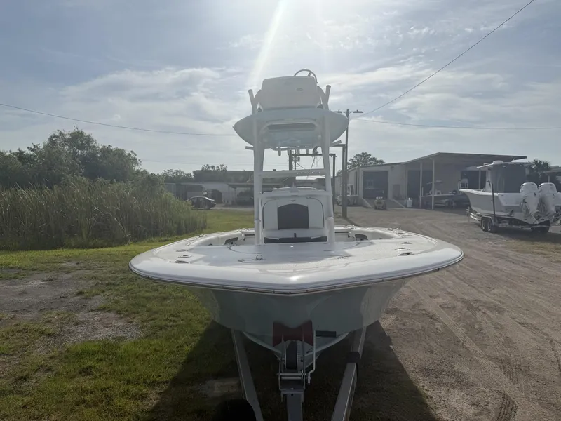 Slide: The Image of 2024 Tidewater 2500 Carolina Bay boat on trailer, parked outdoors under a sunny sky. - 36