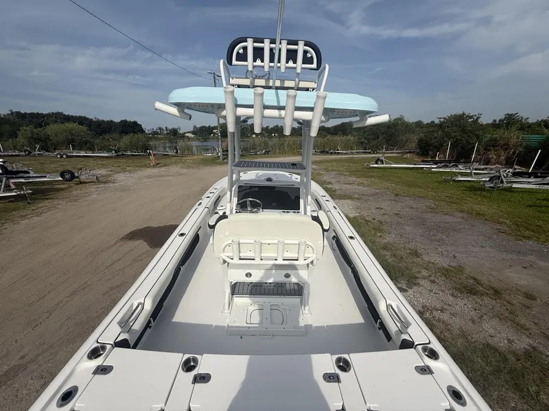 Slide: The Image of 2024 Tidewater 2500 Carolina Bay boat with T-top, viewed from above, in a grassy area. - 38