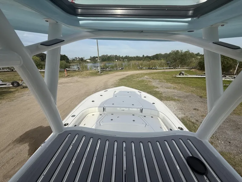 Slide: The Image of 2024 Tidewater 2500 Carolina Bay boat, view from deck, near water and greenery. - 40