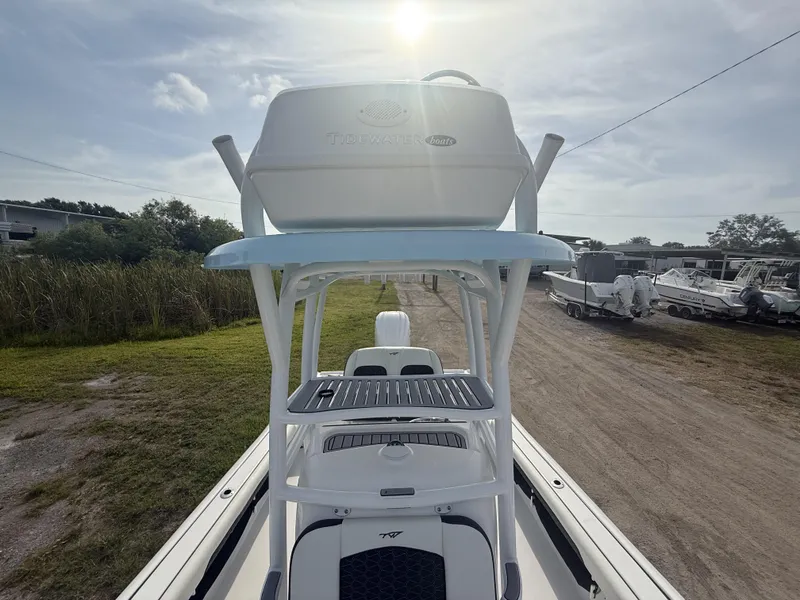 Slide: The Image of 2024 Tidewater 2500 Carolina Bay boat with elevated helm station under a bright sky. - 43