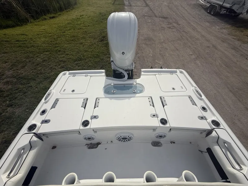 Slide: The Image of 2024 Tidewater 2500 Carolina Bay boat, featuring spacious deck and modern outboard motor. - 44