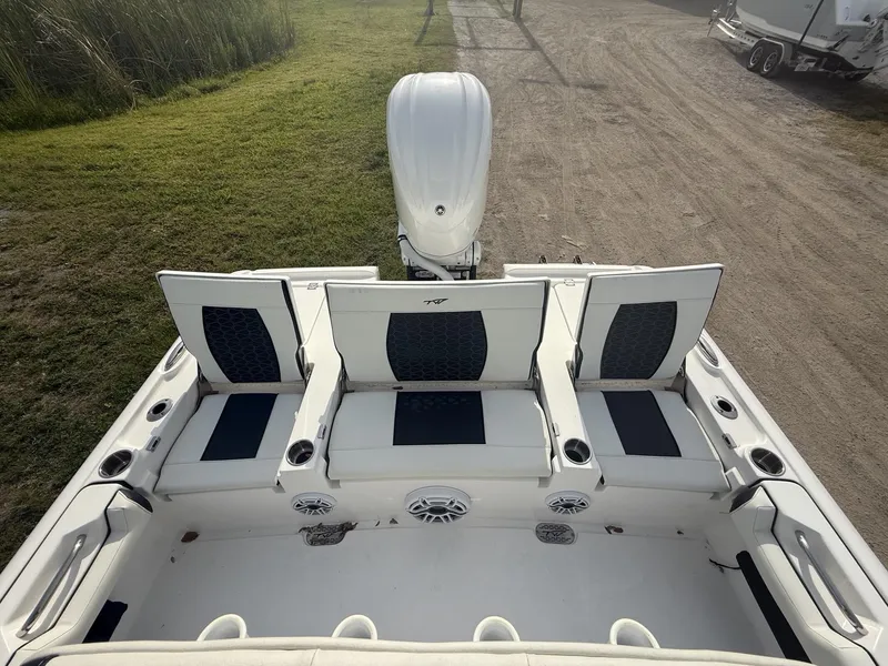 Slide: The Image of 2024 Tidewater 2500 Carolina Bay boat interior with seating and motor, viewed from above. - 45