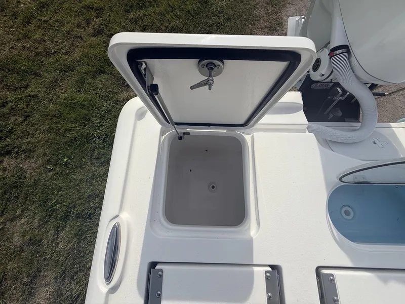 Slide: The Image of 2024 Tidewater 2500 Carolina Bay boat storage compartment open, showcasing interior space. - 46