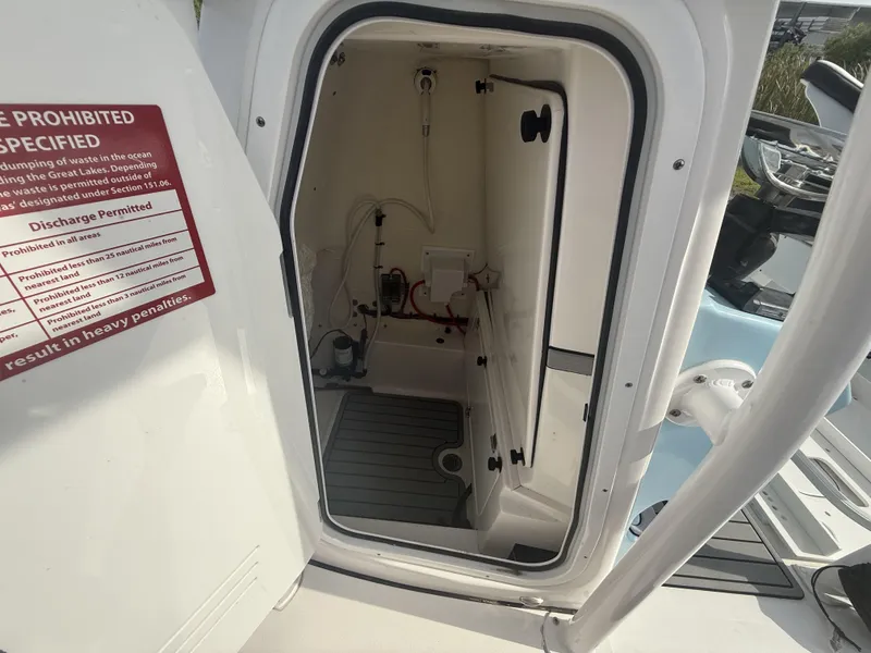Slide: The Image of 2024 Tidewater 2500 Carolina Bay boat interior with open hatch and visible equipment. - 48
