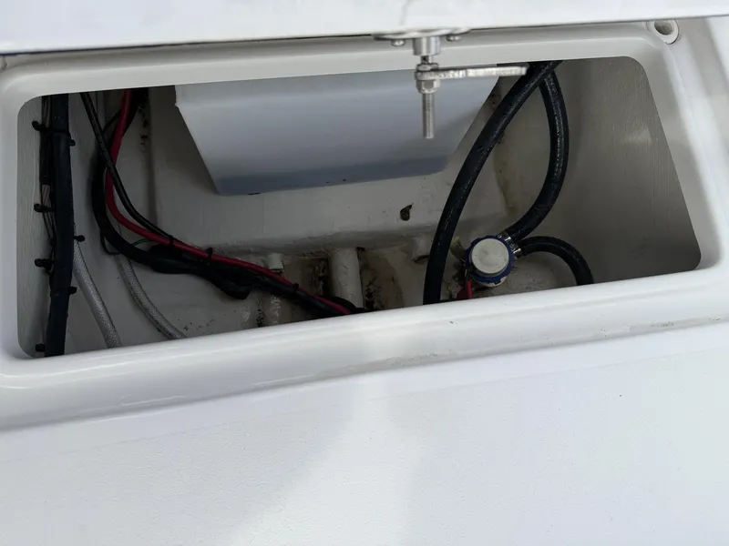 Slide: The Image of 2024 Tidewater 220 CC Adventure boat compartment with wiring and components. - 10