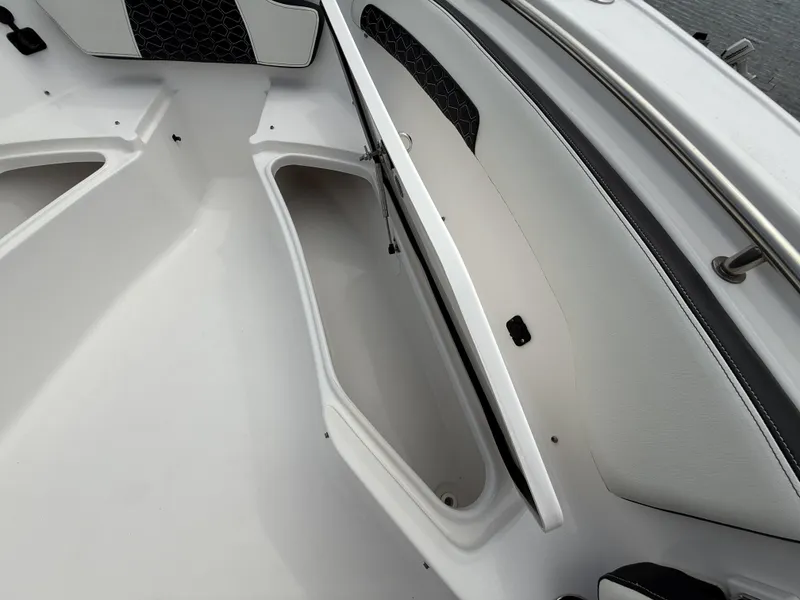 Slide: The Image of 2024 Tidewater 220 CC Adventure boat interior with open storage compartment. - 12