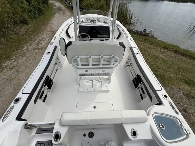 Slide: The Image of 2024 Tidewater 220 CC Adventure boat interior, featuring spacious seating and modern design by the water. - 19