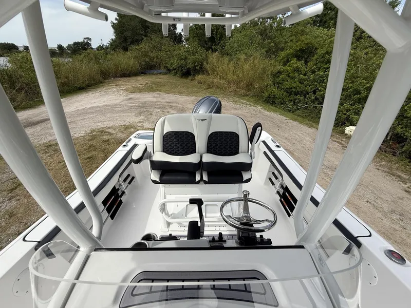 Slide: The Image of 2024 Tidewater 220 CC Adventure boat interior with dual seats and steering wheel. - 27