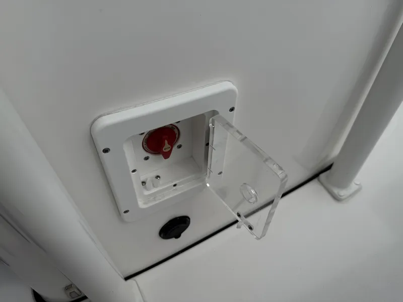 Slide: The Image of 2024 Tidewater 220 CC Adventure boat battery switch with protective cover. - 31