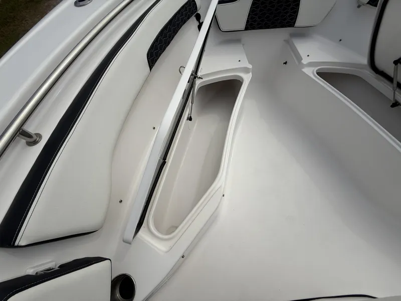 Slide: The Image of 2024 Tidewater 220 CC Adventure boat interior with white seating and storage compartments. - 34