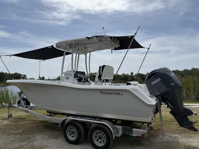 Slide: The Image of 2024 Tidewater 220 CC Adventure boat on trailer with Yamaha engine, parked outdoors. - 36