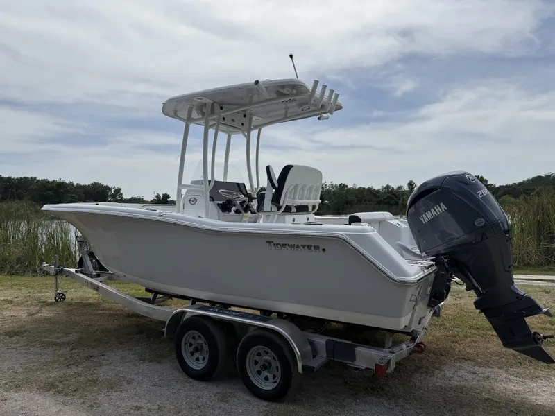 Slide: The Image of 2024 Tidewater 220 CC Adventure boat on trailer with Yamaha outboard motor. - 4