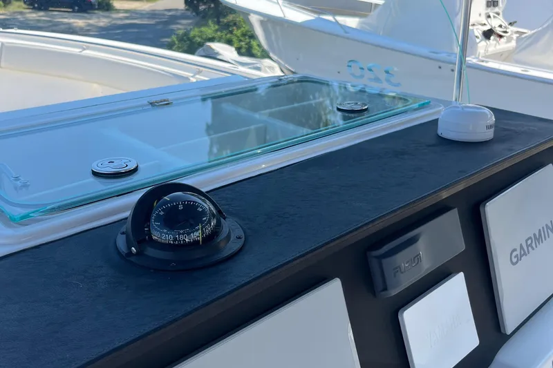 Slide: The Image of Control panel of 2022 Sailfish 320 CC boat with compass and Garmin electronics. - 16