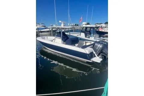 Slide: The Image of 2022 Sailfish 320 CC boat docked in marina under clear blue sky. - 22