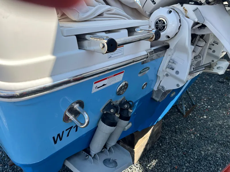 Slide: The Image of 2022 Sailfish 320 CC boat stern with motor and blue hull. - 6