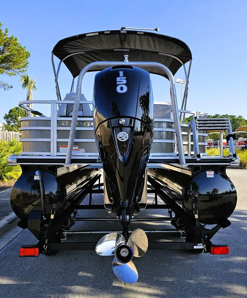 Slide: The Image of 2024 Ranger Reata 220F pontoon boat with powerful 150 HP engine, rear view. - 1