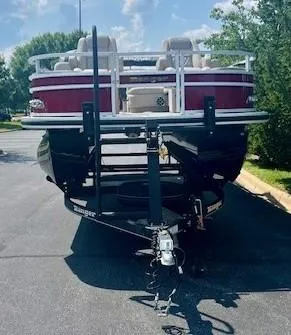Slide: The Image of 2024 Ranger Reata 220F pontoon boat on trailer, front view. - 2