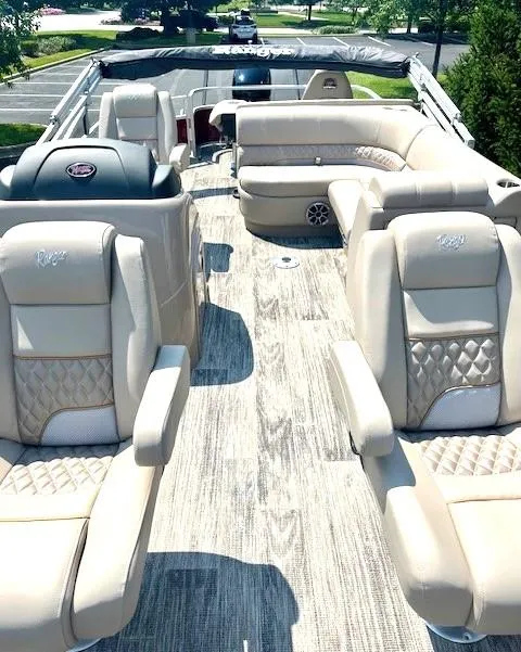 Slide: The Image of 2024 Ranger Reata 220F luxury pontoon boat interior with plush seating. - 3