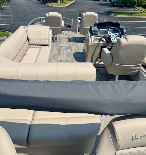 Slide: The Image of 2024 Ranger Reata 220F boat interior with beige seating and modern dashboard. - 4