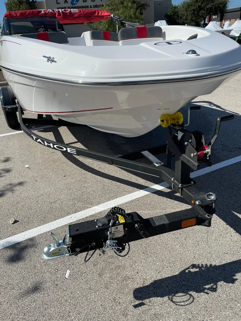Slide: The Image of 2024 Tahoe T16 boat on trailer in parking lot. - 47