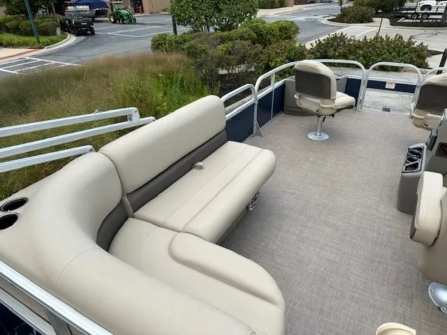 Slide: The Image of 2024 Sun Tracker Bass Buggy 18 DLX pontoon boat with beige seating and spacious deck. - 5